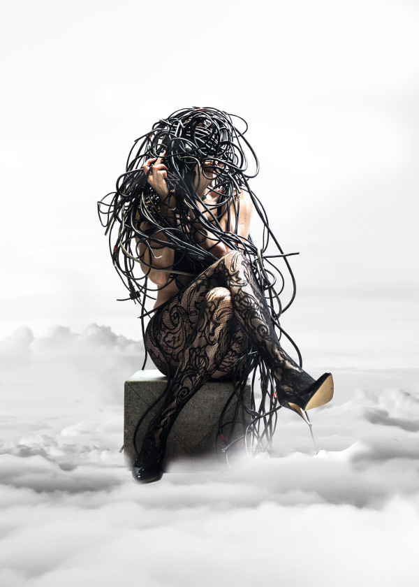 Woman with her head in tangled cords.